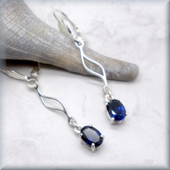 Blue sapphire earrings with wave accent