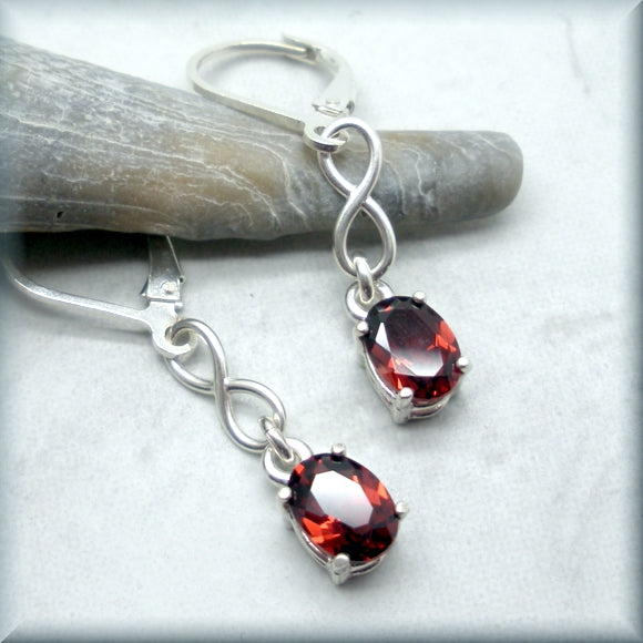 Oval garnet earrings with infinity knot accent