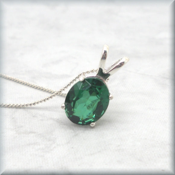 Emerald necklace in sterling silver basket setting