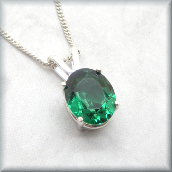 
                  
                    Oval cut simulated emerald on sterling silver curb chain
                  
                