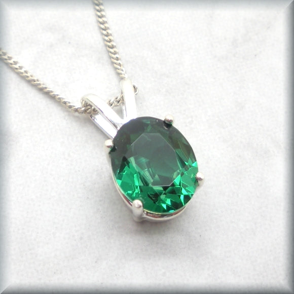 Oval cut simulated emerald on sterling silver curb chain